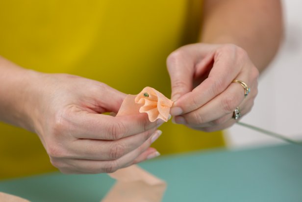 Wrap the crepe paper around the floral stem, creating tiny pleats as you turn the base.