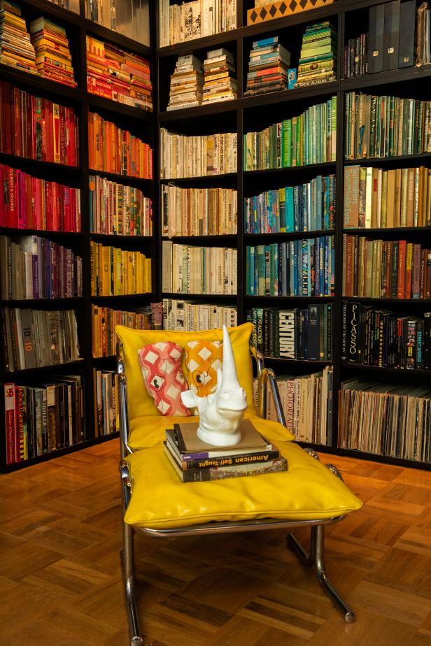 A Yellow Chair Sitting Within a Color-Coordinated Library ...