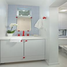 Blue and White Bathroom With Red Faucet