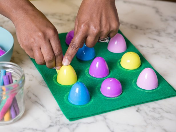 Plastic eggs are traced to create perfect circles for an Easter candy matching game.