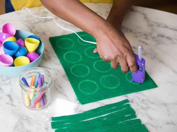 This felt game board is being put together with hot glue.