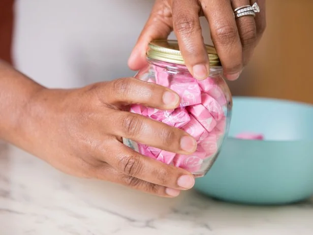 This glass jar has been completely filled with candy.