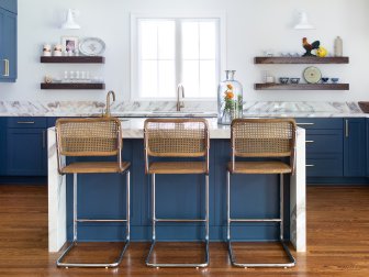 Cane-back stools pop against a deep blue kitchen island (and complement the wooden floors!) in this space designed by Mary Patton of Mary Patton Design. “Rather than doing an upholstered bar stool, these are very easy to clean and comfortable,” Mary tells HGTV.com.
