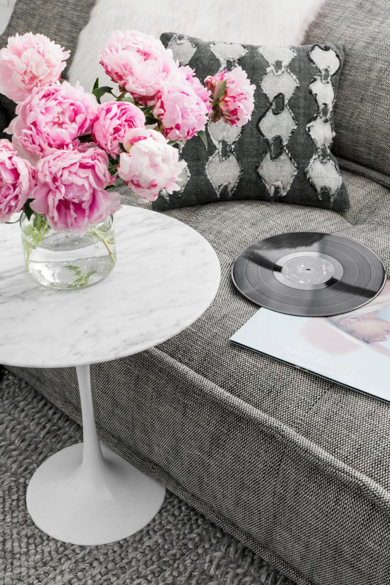 To keep the decor timeless, Brian used all organic materials for the room's design. The low slung sofas are upholstered in tweed; the accent tables are carrara marble; and the over sized carpet is wool.