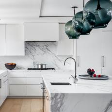 Modern White Kitchen With Globe Pendants