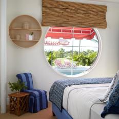Guest Room With Round Window Overlooking Pool
