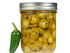 A jar of canned jalapeno peppers.