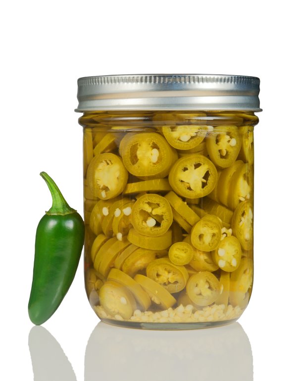 A jar of canned jalapeno peppers.