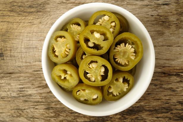 Slices of pickled jalapenos in a bowl, ready to be incorporated into recipes.