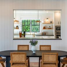 Gorgeous Dining Table and Chairs Sitting Beneath Window to Kitchen