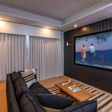Stylish In-Home Theatre Room With Shiplap Walls and Black Accent Wall