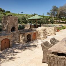 Outdoor Kitchen and Fireplace Offers Poolside Dining