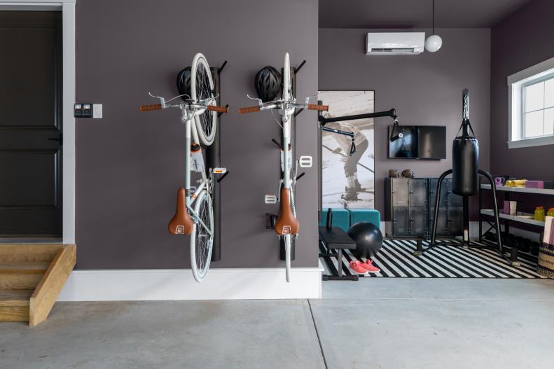 Home Gym in Corner of Garage Near Wall-Mounted Bike Racks