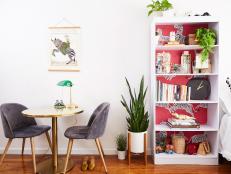 Apartment Dining Nook With Table and Two Chairs Beside Bookshelf