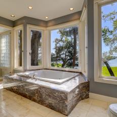 Gray Spa Bathroom With Marble Soaking Tub