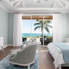 Blue and White Coastal Bedroom With Patio Access