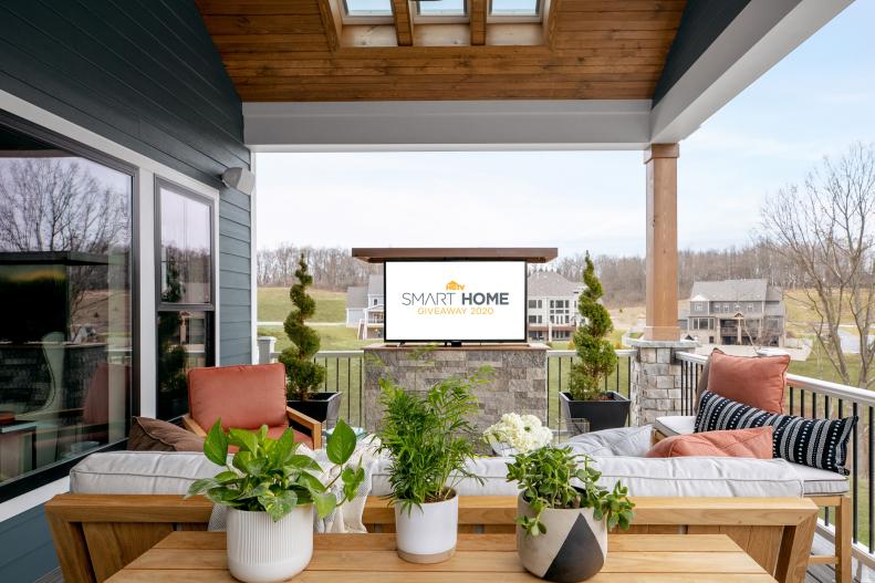 Covered Deck Includes Concealed TV That Rises From a Stone Cabinet