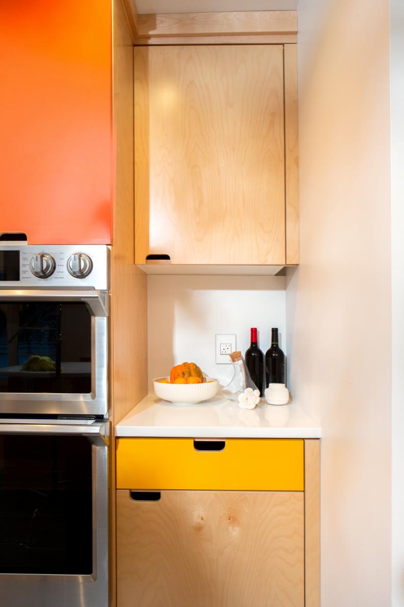 Birch, and yellow and orange laminate cabinetry in a midcentury home.