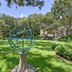 Patinaed Armillary Globe Sculpture Sitting in Front Lawn 