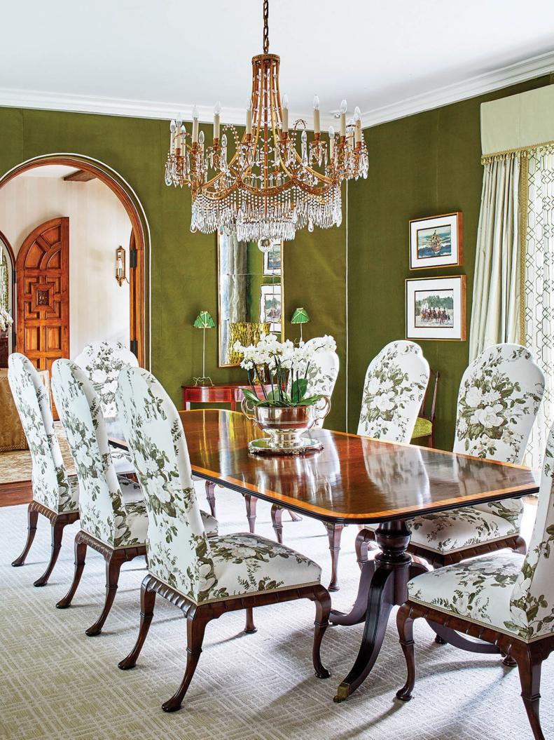 Traditional Dining Room With Green Walls and Ornate Tiered Chandelier