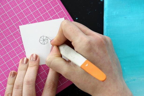 Make a pattern for your umbrella by drawing four intersecting ½” lines on a piece of cardstock. Cut it out to get an octagon shape. Make a separate pattern for each umbrella color you will be painting.