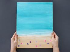 Bring the ocean right into your living room with this fun, easy-to-make DIY beach scene painting. Make it on your own or at a paint night with friends. And the best part is, it’s easily adaptable to any size or shape canvas you already have.