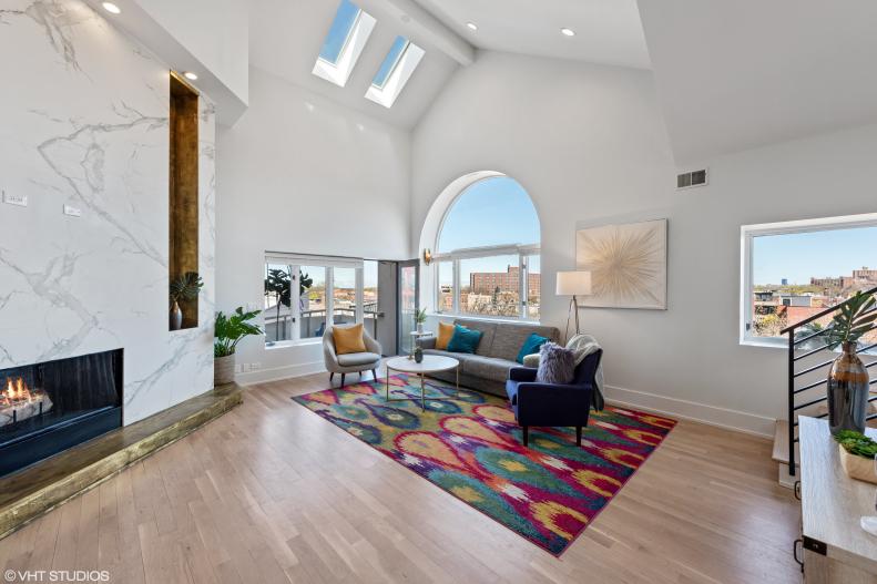 Living Room With Skylights, Marble Fireplace and Colorful Seating