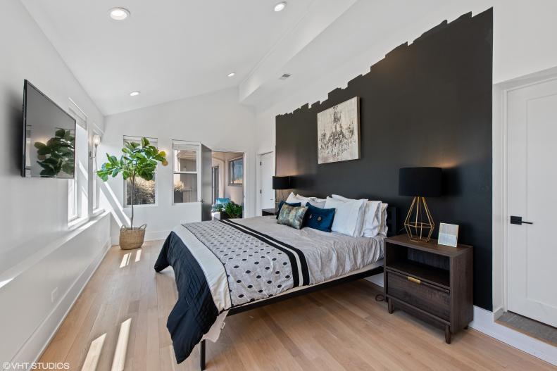 Black Painted Accent Wall in Modern Bedroom with TV, Oversized Windows