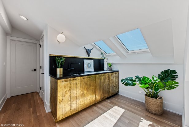 Attic Wet Bar With Gold Tone Finish, Skylights and Door to Patio