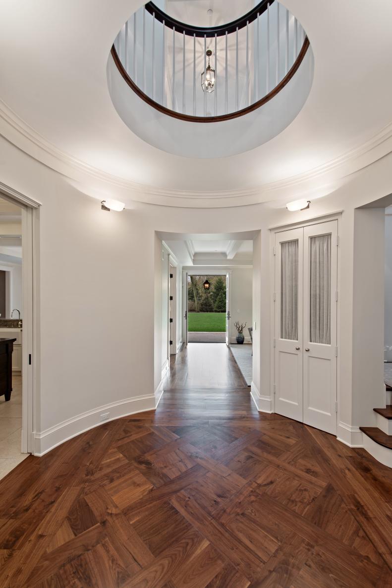 Round Foyer With Hardwood Floors, Open Ceiling View to Second Floor
