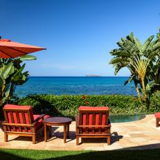 Oceanfront Patio With Red Chairs
