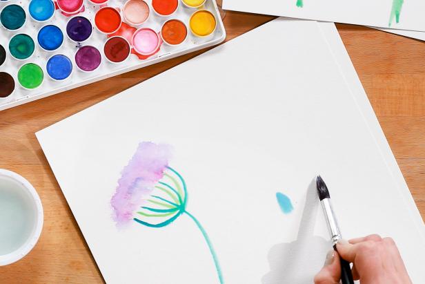 To paint a bluebell flower, create petals by loading up a large brush with water and blue paint, and pressing it down onto the paper. Add more blue paint to the tips of each petal.