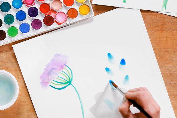 To paint a bluebell flower, create petals by loading up a large brush with water and blue paint, and pressing it down onto the paper. Add more blue paint to the tips of each petal.