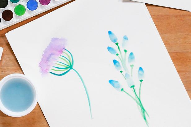 Use green paint and a smaller brush to add stems under each petal to finish your bluebell flower.
