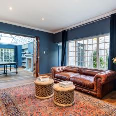 Bold Blue Living Space With Tufted Leather Sofa
