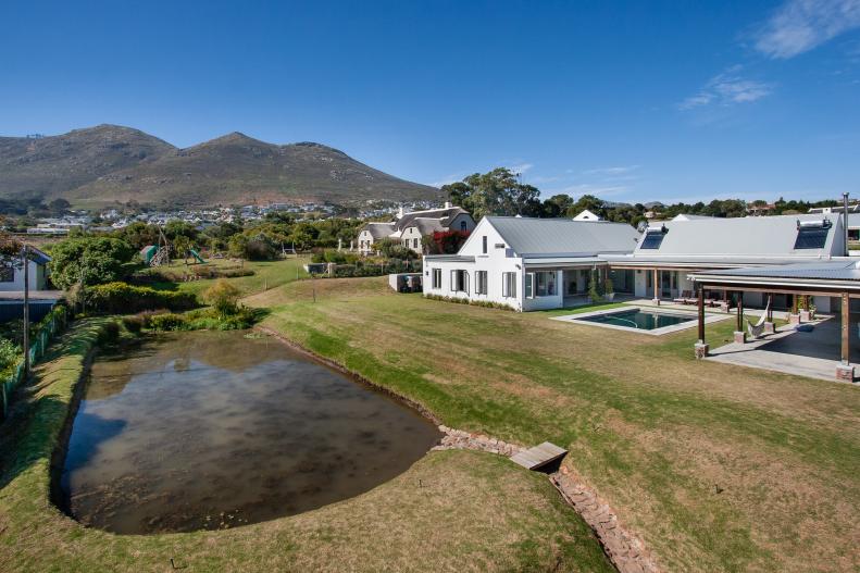 Aerial View of Hillside Modern Ranch Backyard With Pond, Swimming Pool