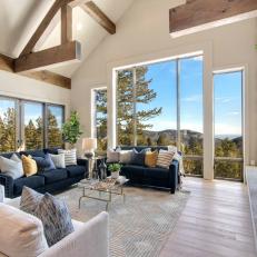 Massive Modern Living Room With Extravagant Exposed Beams and Natural Light Throughout