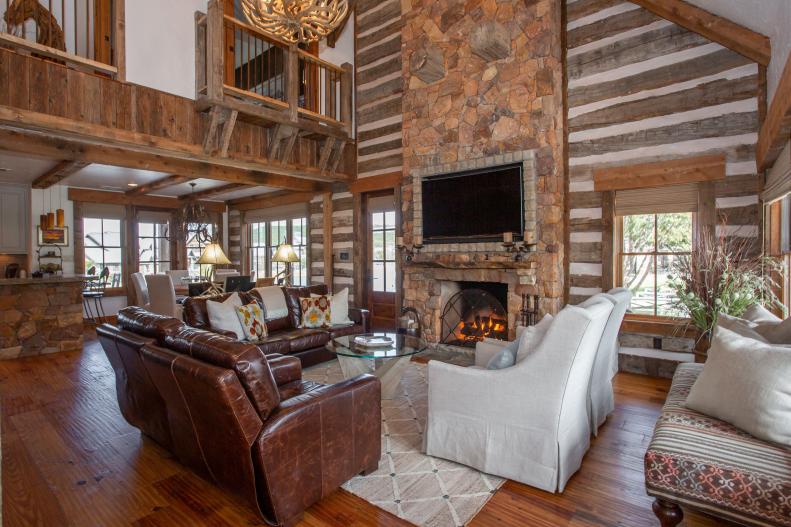Living Room With Stone Fireplace and Log Cabin Walls
