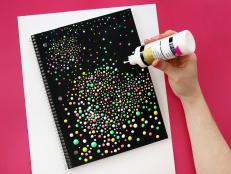Adding White Dots of Puffy Paint to Black Notebook