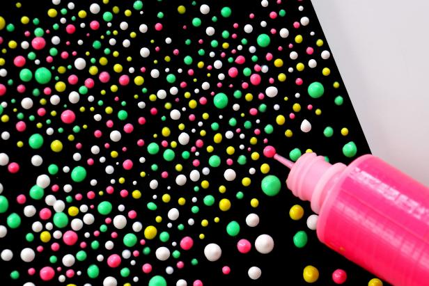 Use puffy paint to add dots all over the notebook cover. Feel free to use as many colors as you like and make any design you want.