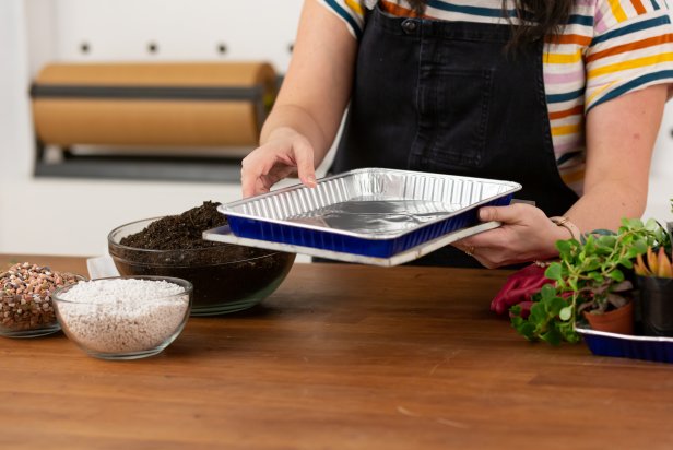 As each vintage birdcage is different, pick a disposable aluminum baking pan that best fits the tray inside your cage. As succulents are desert plants, they don’t thrive well with moisture in their roots, or in humid air, so start by adding a bed of rocks to the aluminum baking pan. Then, add a layer of perlite; this helps to promote drainage and keeps the hanging planter light-weight.