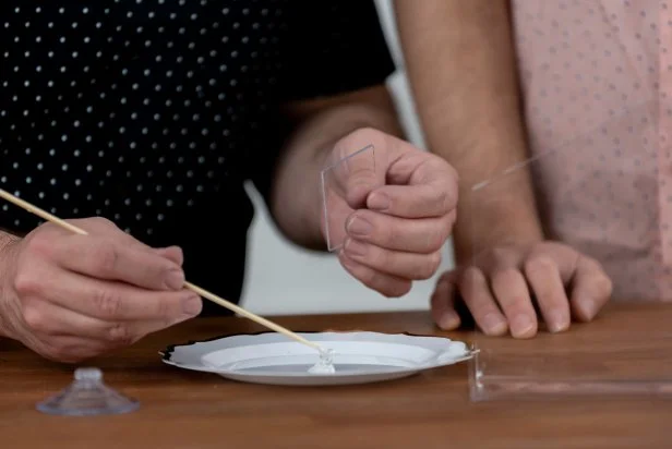 Use a wooden skewer to apply a thin coat of waterproof super glue to the roof and sides of the tray and glue together. Then, make a perch by adding a wooden dowel to the edge of the tray using waterproof super glue. Let dry for 24 hours. Tip: Use painter’s tape and a scrap piece of cardboard to hold the bird feeder in place as it dries.