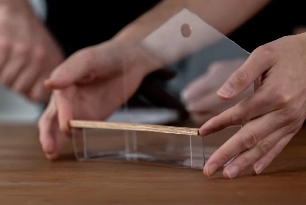 Then, make a perch by adding a wooden dowel to the edge of the tray using waterproof super glue. Let dry for 24 hours.