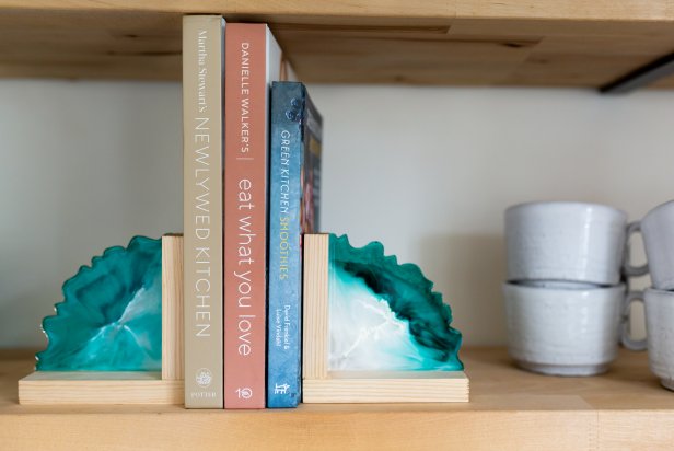 Resin Bookends Flanking Three Books on Floating Shelf