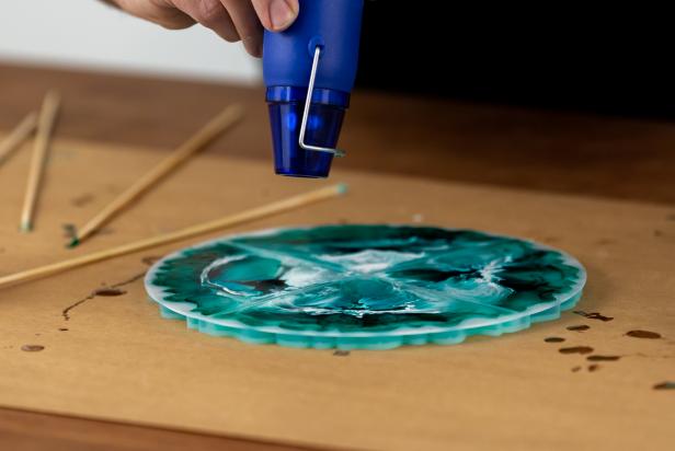 Use a embossing heat gun to remove any bubbles from the poured resin mixture in the mold.