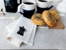 Stenciled Tea Towel With Coffee Pot Icon Beside Coffee and Bagels