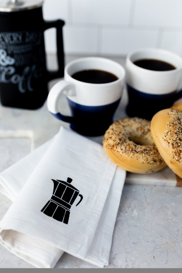 Stenciled Tea Towel With Coffee Pot Icon Beside Coffee and Bagels