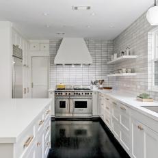 Modern White Kitchen With Stainless Steel Appliances and Gold Hardware