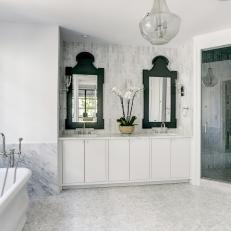 Elegant White Master Bathroom With Luxurious Marble Tub Surround
