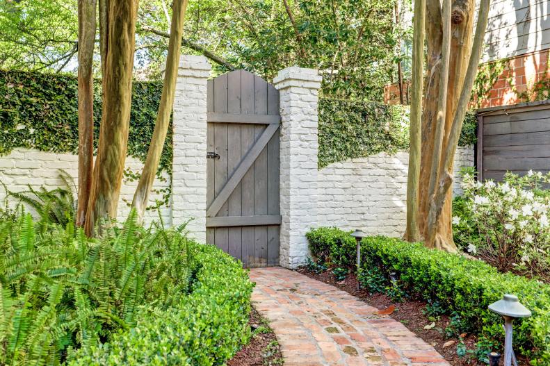 Handcrafted Wooden Gate in Painted Brick Wall 